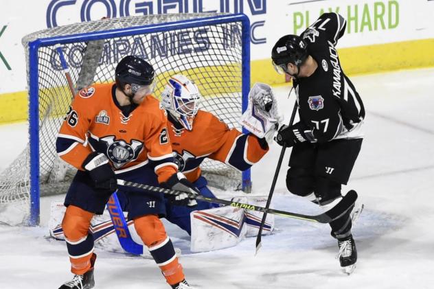 Worcester Railers goaltender Ken Appleby makes a stop while defenseman Jared Brandt stands ready
