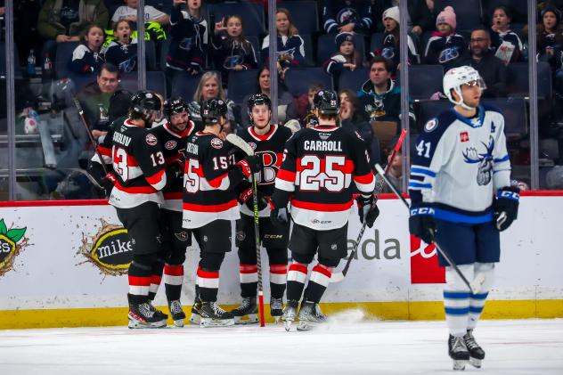 Belleville Senators gather after a goal against the Manitoba Moose