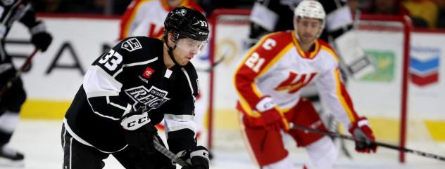 Ontario Reign's Tobias Bjornfot And Calgary Wranglers' Kevin Rooney In Action
