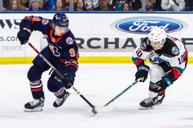 Kelowna Rockets left wing Turner McMillen (right) skates against the Kamloops Blazers