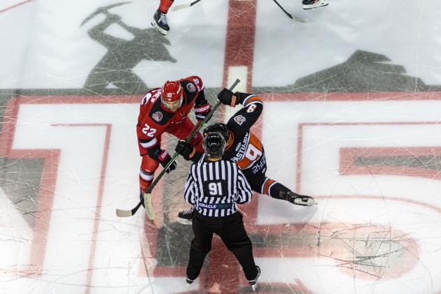 Rapid City Rush forward Matt Marcinew (left) in the faceoff circle