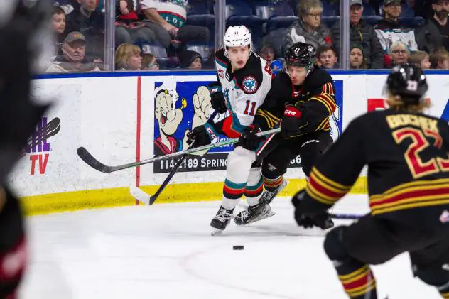 Kelowna Rockets' Carson Golder battles Vancouver Giants' Skyler Bruce