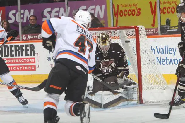 Lehigh Valley Phantoms' Louie Belpedio battles Hershey Bears' goaltender Zach Fucale