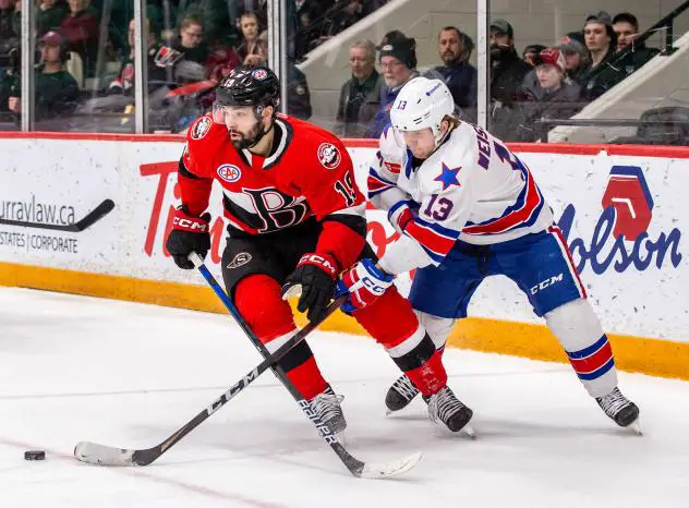 Belleville Senators' John Quenneville and Rochester Americans' Linus Weissbach in action