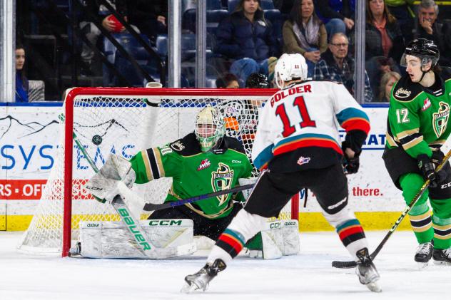 Prince Albert Raiders' Max Hildebrand and Landon Kosior and Kelowna Rockets' Carson Golder in action