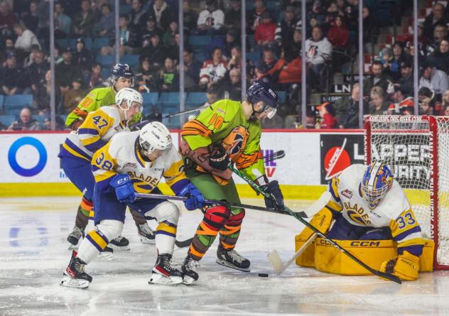 Saskatoon Blades' Trevor Wong and Ethan Chadwick battle Kamloops Blazers' Conner Radke