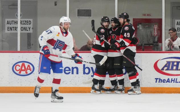 Laval Rocket's Brandon Gignac and Belleville Senators' Cole Cassels, Egor Sokolov and Scott Sabourinon game night