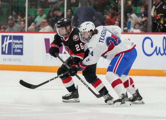 Belleville Senators centre Brennan Saulnier (left) vs. the Laval Rocket