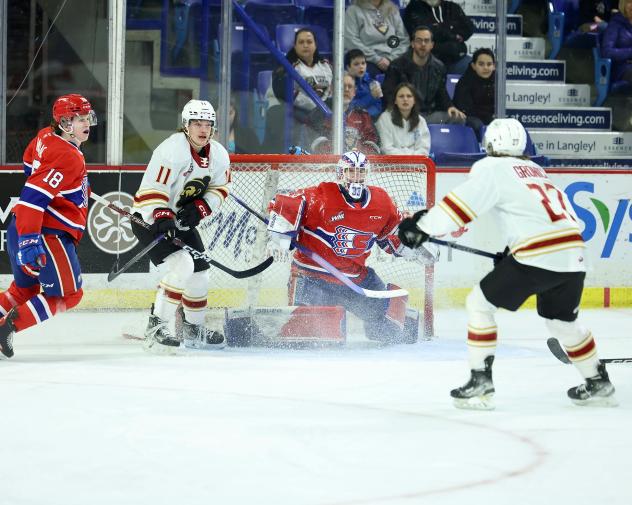Vancouver Giants right wing Skyler Bruce (left of goal) and centre Kyren Gronick (far right) vs. the Spokane Chiefs