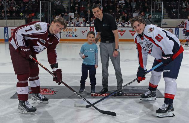 Peterborough Petes' Shawn Spearing and Windsor Spitfires' Matthew Maggio with Petes' Mental Health Coach Jack Veitch and his son Bear