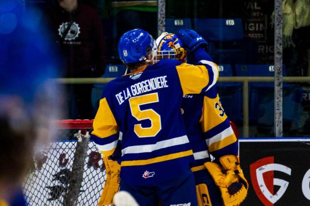 Saskatoon Blades' Aidan De La Gorgendiere and Ethan Chadwick celebrate win