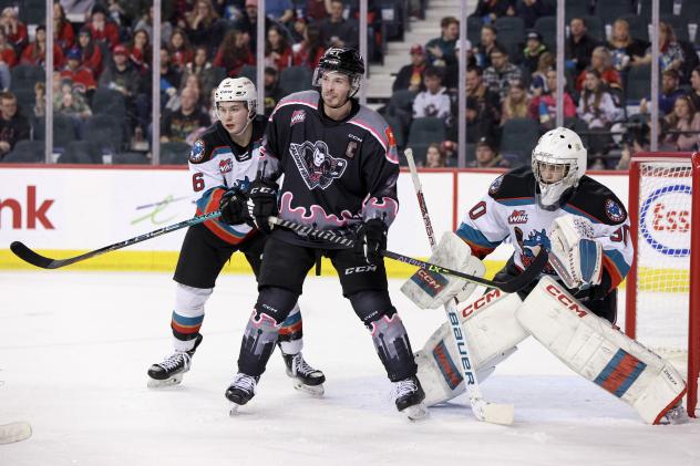 Calgary Hitmen's Riley Fiddler-Schultz and Kelowna Rockets' Marek Rocak and Jari Kykkanen on game night