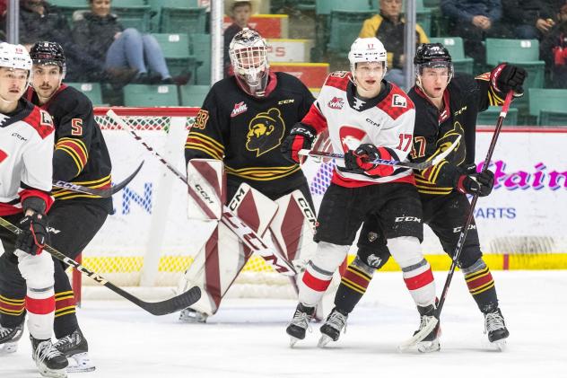 Vancouver Giants' Carson Haynes, Brett Mirwald and Mazden Leslie and Prince George Cougars' Zac Funk on game night