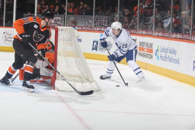 Lehigh Valley Phantoms' Adam Ginning battles Toronto Marlies' Pontus Holmberg