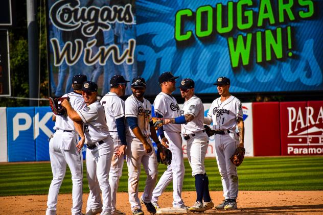 Kane County Cougars exchange congratulations after a win