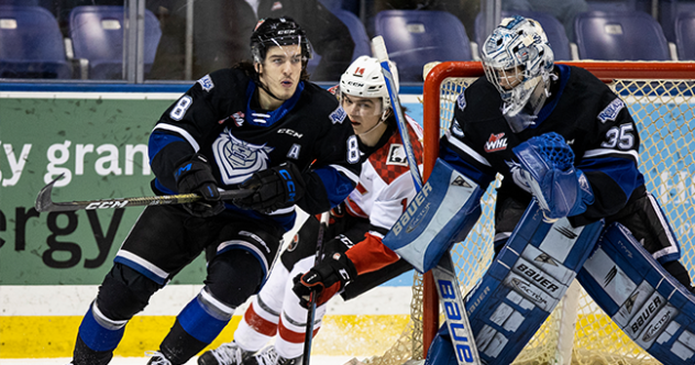 Victoria Royals' Kalem Parker and Nicholas Cristiano and Prince George Cougars' Cayden Glover in action