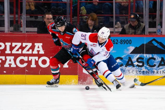 Kelowna Rockets' Turner McMillen battles Spokane Chiefs' Cameron Parr
