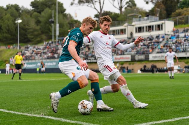 Phoenix Rising's Emil Cuello (in white) defends a cross against the San Diego Loyal