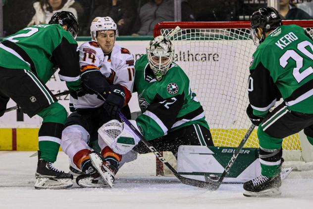 Coachella Valley Firebirds' Austin Poganski battles Texas Stars' Ryan Shea, Matthew Murray and Tanner Kero