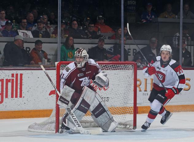 Peterborough Petes' Michael Simpson and Ottawa 67's' Jack Dever in action