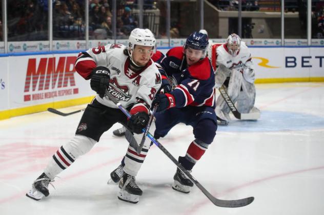 Guelph Storms' Jake Murray battles Saginaw Spirit's Bode Stewart