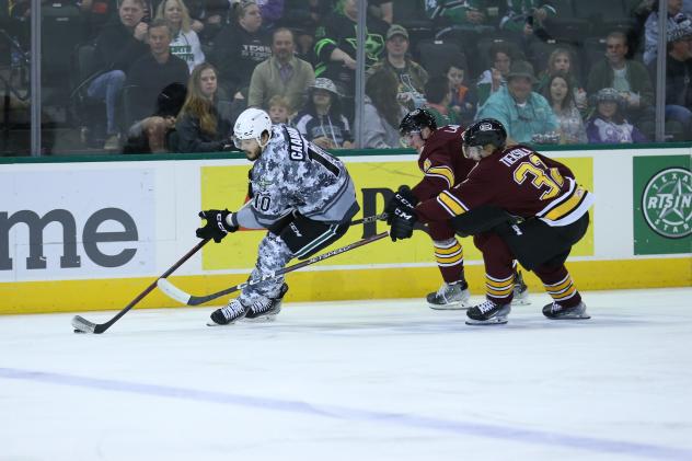 Texas Stars' Nicholas Caamano and Chicago Wolves' Tuukka Tieksola in action