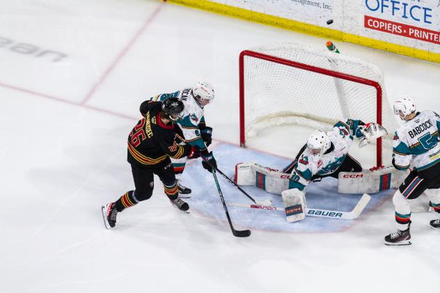 Vancouver Giants' Justin Ivanusec battles Kelowna Rockets' Jari Kykkanen