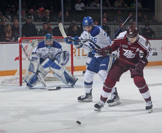 Sudbury Wolves' Dylan Robinson battles Peterborough Petes' Konnor Smith