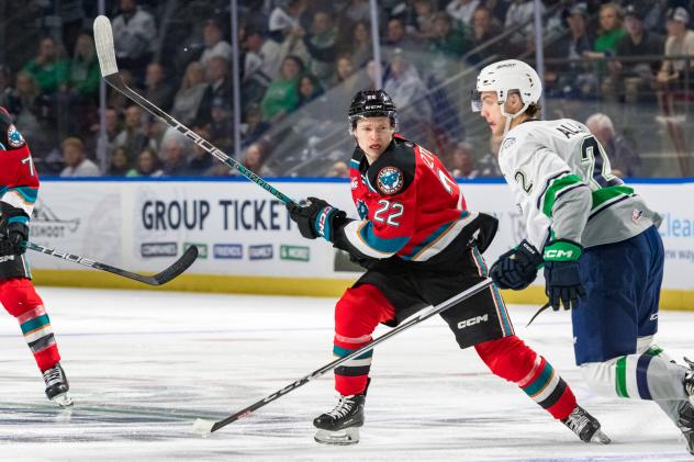 Kelowna Rockets' Gabriel Szturc and Seattle Thunderbirds' Nolan Allan in action