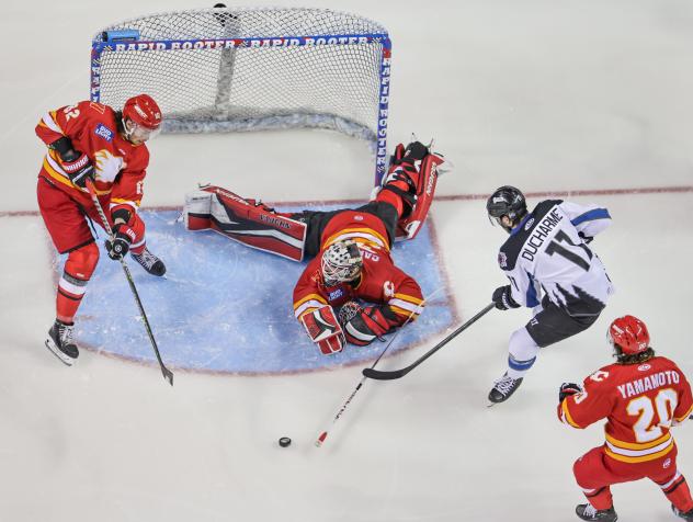 Rapid City Rush's Carter Robertson, Adam Carlson and Keanu Yamamoto battle Idaho Steelheads' Justin Ducharme