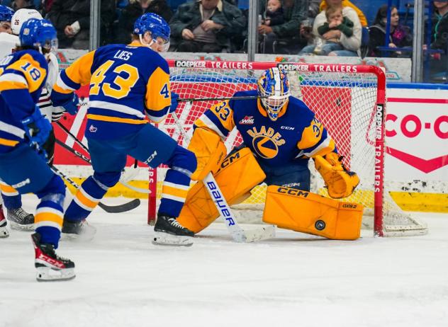 Saskatoon Blades' Justin Lies and Ethan Chadwick in action