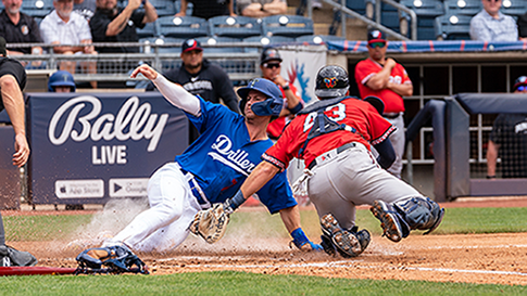 Jonny DeLuca of the Tulsa Drillers slides safely into home