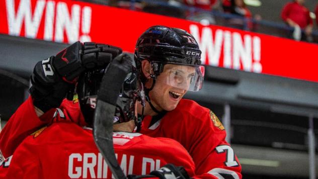 Rockford IceHogs' Rocco Grimaldi and Alec Regula celebrate win