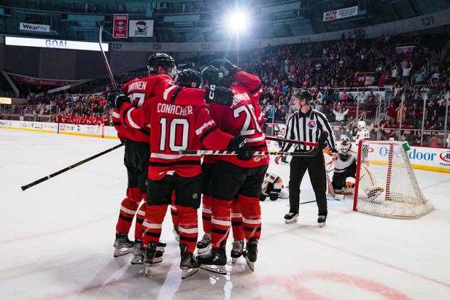 Charlotte Checkers' Santtu Kinnunen, Cory Conacher and Connor Bunnaman celebrate win
