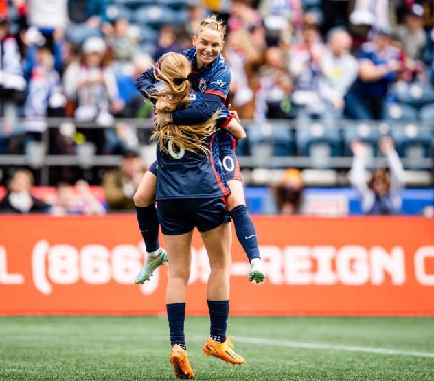 OL Reign midfielcder Jess Fishlock and forward Bethany Balcer celebrate a goal