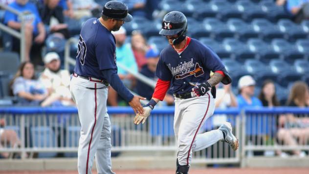 Mississippi Braves' coach Kanekoa Texeira congratulates Javier Valdes