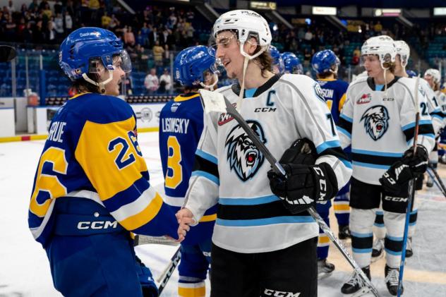 Saskatoon Blades' Spencer Shugrue congratulates Winnipeg ICE's Carson Lambos