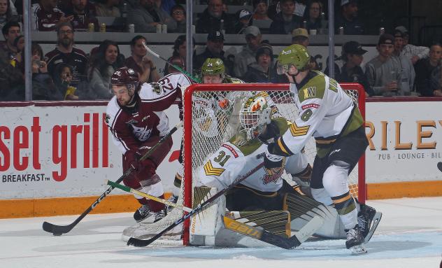 Peterborough Petes' Avery Hayes and North Bay Battalion's Dom DiVincentiis and Avery Winslow in action