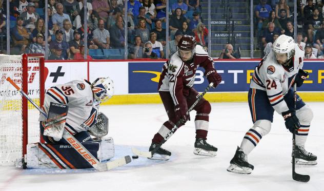 Peterborough Petes' Tucker Robertson battles Kamloops Blazers' Dylan Ernst and Ethan Brandwood