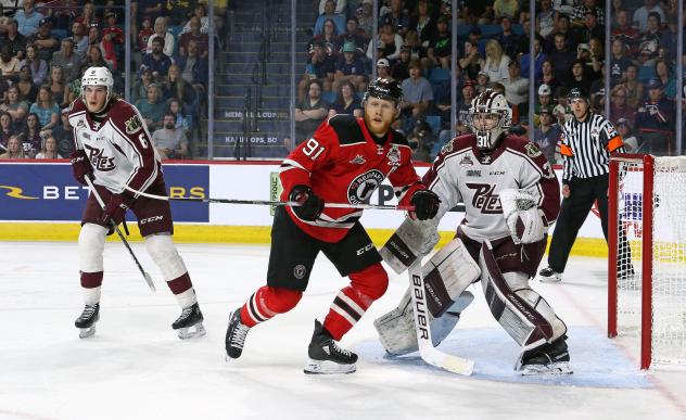 Quebec Remparts' Nathan Gaucher battles Peterborough Petes' Michael Simpson