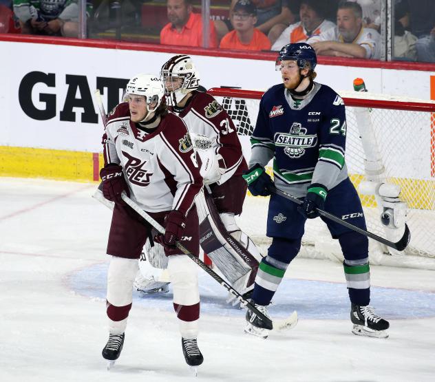 Peterborough Petes' Konnor Smith and Michael Simpson and Seattle Thunderbirds' Reid Schaefer on the ice