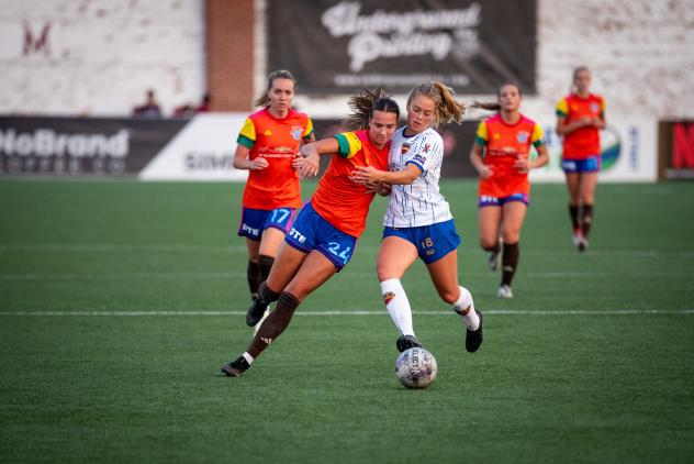Detroit City FC's Kenna White battles Flint City AFC's Alana Wood