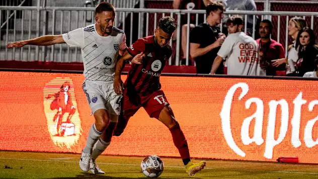 Louisville City FC's Sean Totsch battles Phoenix Rising FC's Danny Trejo
