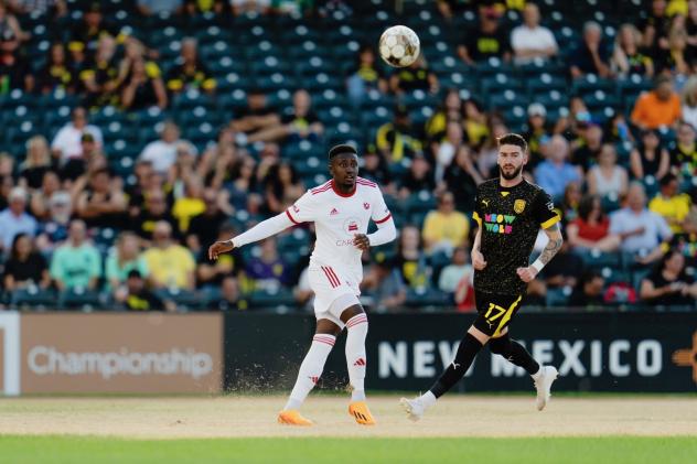 Phoenix Rising FC's Eddie Munjoma and Tampa Bay Rowdies' Greg Hurst in action