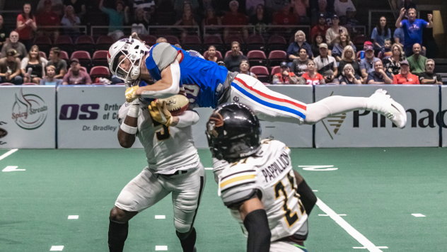 Northern Arizona Wranglers fly in to make a tackle against the Tucson Sugar Skulls