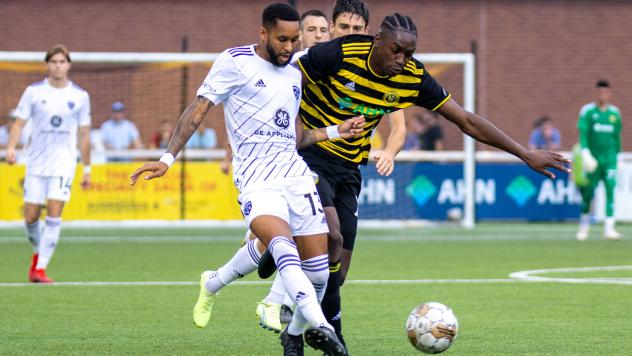 Louisville City FC defender Amadou Dia (left) vs. Pittsburgh Riverhounds SC