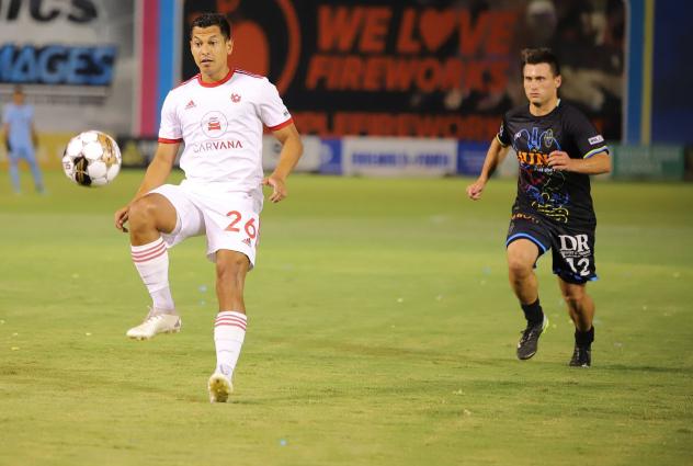 Phoenix Rising FC's Renzo Zambrano and Las Vegas Lights FC's Tyler Bagley on the field