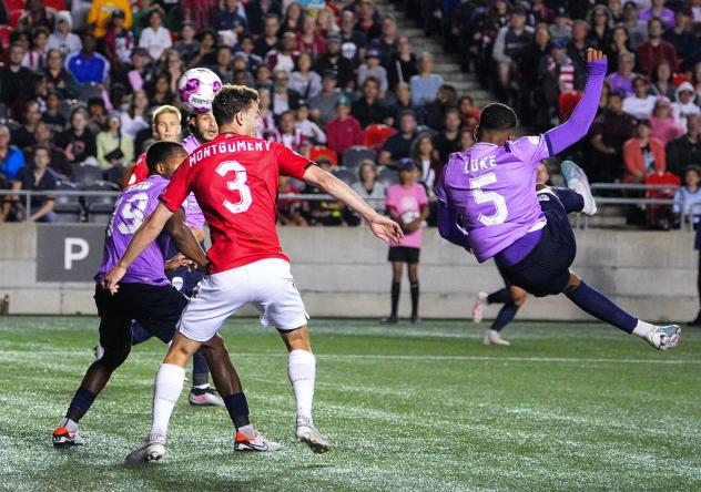 Atlético Ottawa's Luke Adam Singh and Cavalry FC's Callum Montgomery in action