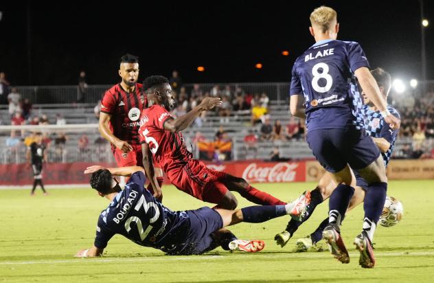 Phoenix Rising FC's Henry Uzochukwu and Tampa Bay Rowdies' Younes Boudadi and Jack Blake in action