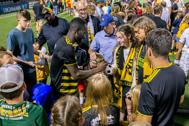 Albert Dikwa of the Pittsburgh Riverhounds signing autographs